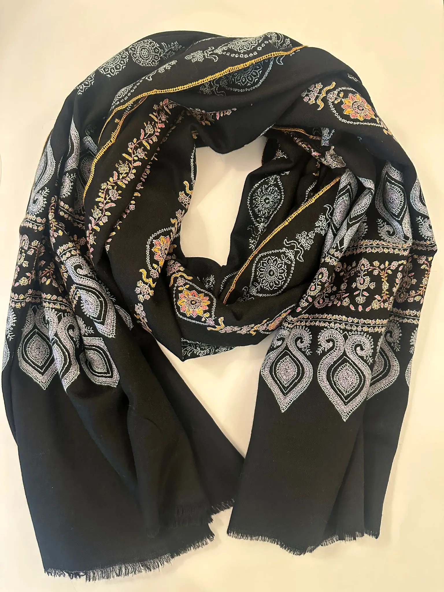 Black stole with bands of ivory and gold paisley needlework.