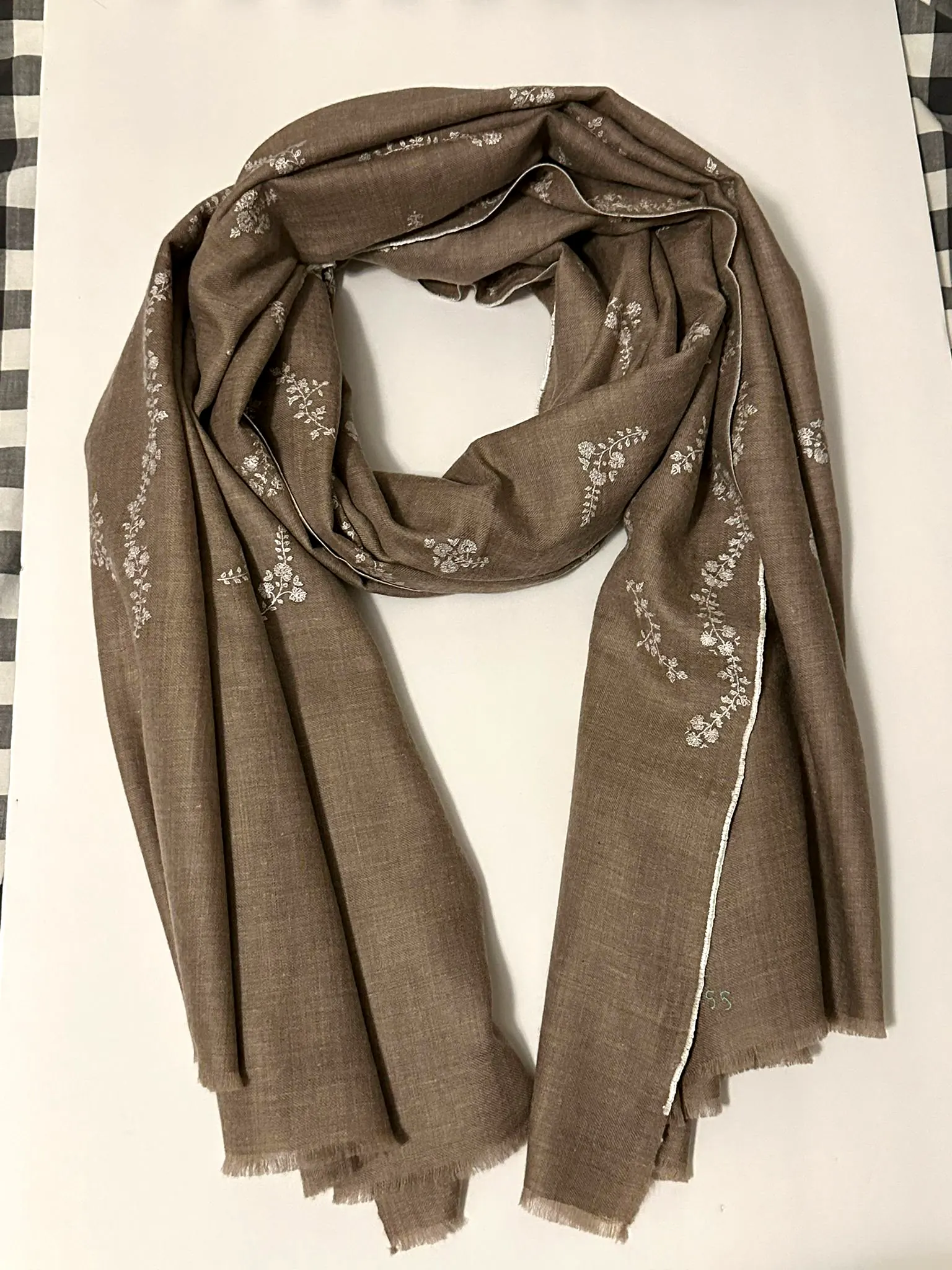 Mushroom stole with small ivory flowers scattered near the ends.