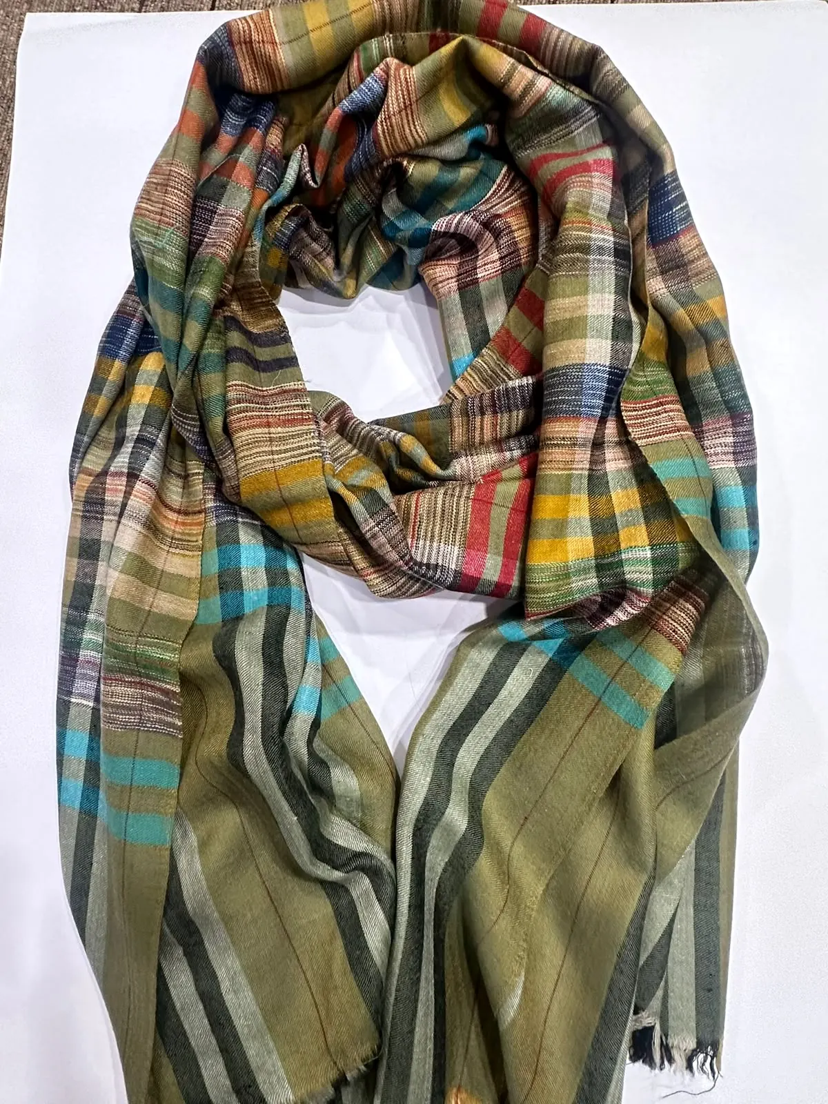 Olive stole with multicoloured stripes and check.