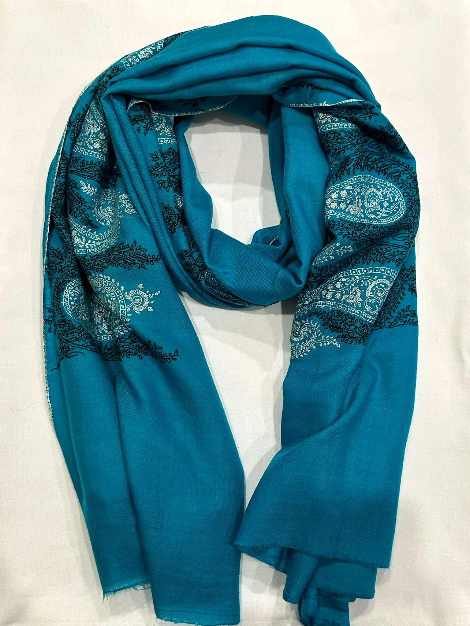Peacock blue stole with dark tonal paisley needlework.