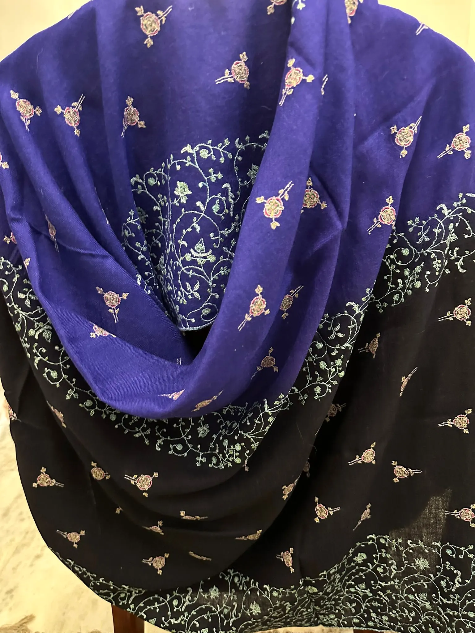 Shawl in violet and black with ivory needlework motifs and jaal bands, draped.